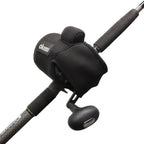 A close-up of a black Okuma fishing reel mounted on a black rod, showing the reel body, handle, and part of the rod against a plain white background.