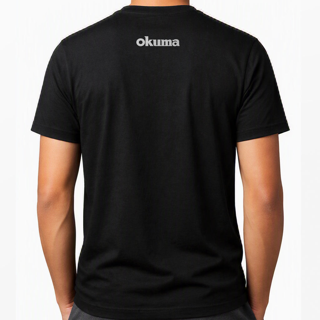 A man wearing a black short-sleeve t-shirt, viewed from the back. The shirt features the brand name 'okuma' printed in white across the upper back.