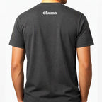 A man wearing a dark gray heather t-shirt, viewed from the back. The shirt features the brand name 'okuma' printed in white across the upper back.