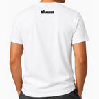 A man wearing a white short-sleeve t-shirt, viewed from the back. The brand name 'okuma' is printed in black sans-serif font on the upper center back.