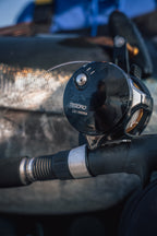 Okuma Tesoro Reel with a tuna n the background